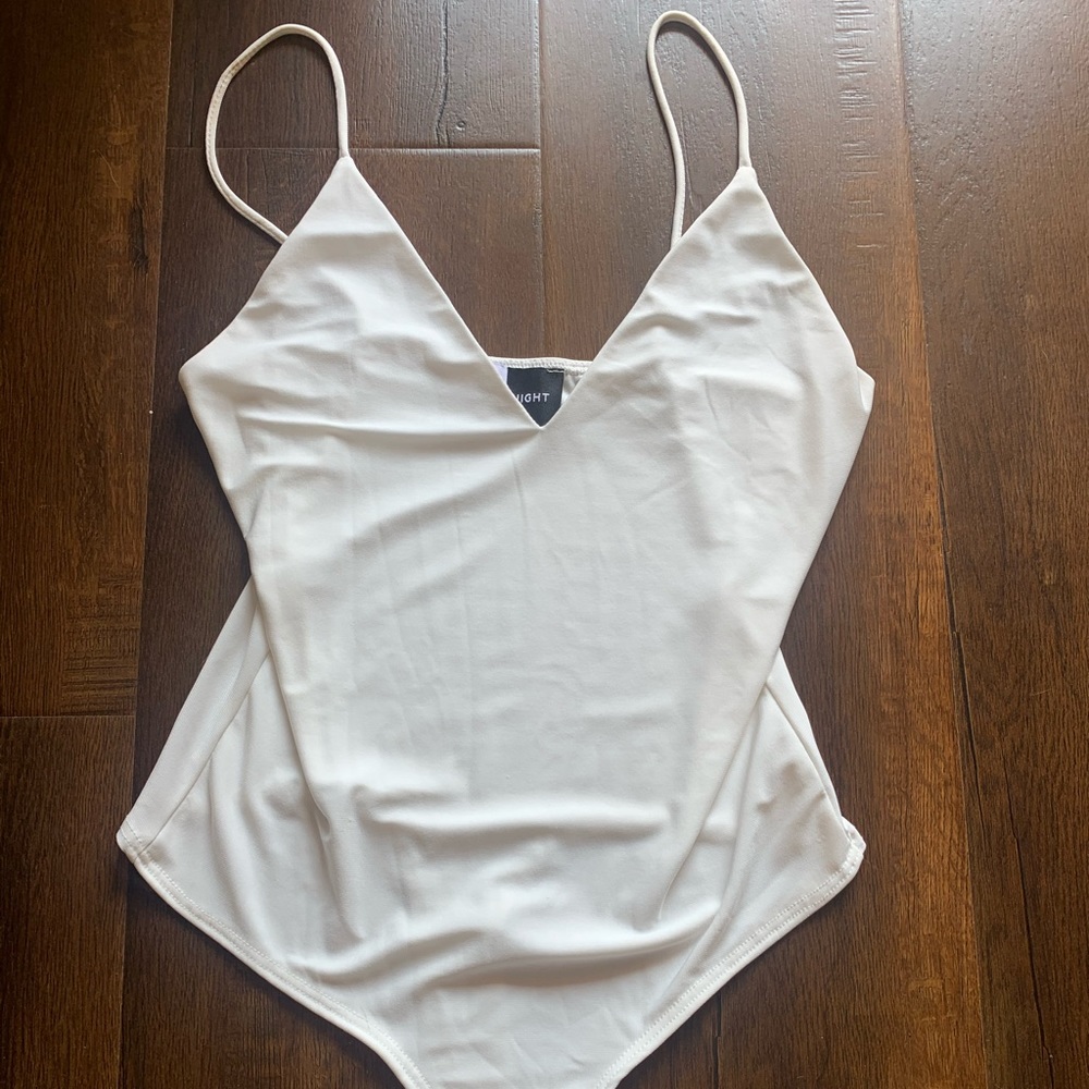 White snap-closure bodysuit/ brand new/ never worn